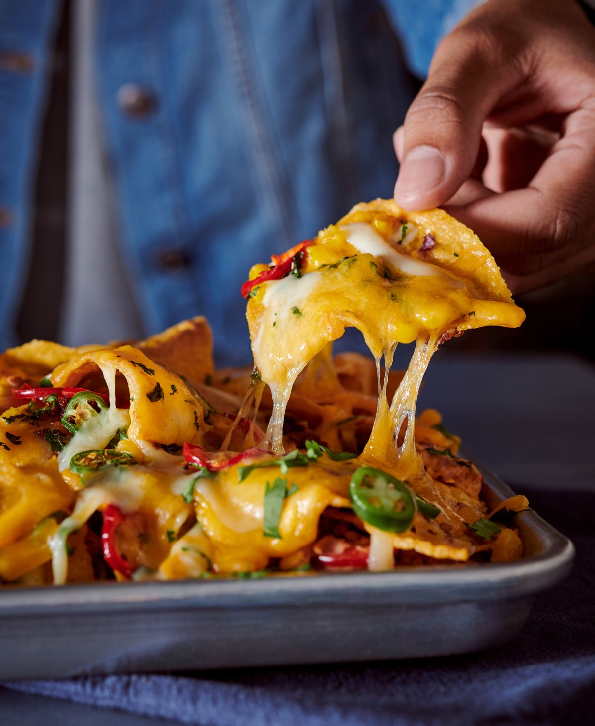 spicy nachos loaded with cheese, jalapenos, and salsa.jpg